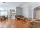 Open-concept living area with wood floors, neutral walls, and view of the kitchen and dining area at 1010 Armillaria St, Henderson, NV 89011