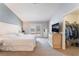Bright main bedroom featuring carpet flooring, a dresser, closet and french doors to the backyard at 1010 Armillaria St, Henderson, NV 89011