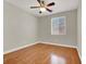 The bedroom features hardwood floors, neutral paint, ceiling fan and a window at 10200 Clark Wooldridge Ct, Las Vegas, NV 89129