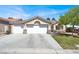 Lovely home with a three-car garage, well-maintained lawn, mature landscaping and beautiful desert landscape at 10200 Clark Wooldridge Ct, Las Vegas, NV 89129