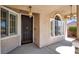 Inviting front porch with decorative lighting, windows, and a secure screen door at 10200 Clark Wooldridge Ct, Las Vegas, NV 89129