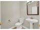 Stylish half bathroom with a pedestal sink, decorative mirror, and neutral paint color at 10200 Clark Wooldridge Ct, Las Vegas, NV 89129