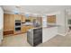 Spacious kitchen features wood cabinetry, tile flooring, granite countertops and stainless steel appliances at 10200 Clark Wooldridge Ct, Las Vegas, NV 89129