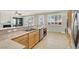 The bright kitchen offers stainless steel appliances, granite countertops, tile flooring, and shuttered windows at 10200 Clark Wooldridge Ct, Las Vegas, NV 89129