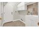 A functional laundry room includes tile flooring, built-in sink and cabinets for ample storage at 10200 Clark Wooldridge Ct, Las Vegas, NV 89129