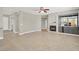 Expansive living room with a fireplace, built-in bar, tile flooring, and natural light at 10200 Clark Wooldridge Ct, Las Vegas, NV 89129