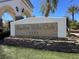This community sign for Shadow Hills Club sits on a stone base with manicured lawn at 10200 Clark Wooldridge Ct, Las Vegas, NV 89129