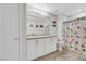Clean bathroom with updated vanity, mirrored lighting, and colorful shower curtain at 1180 Solano Hills Ct, Henderson, NV 89002