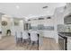 Modern kitchen with a large granite island, stainless steel appliances, and stylish bar stool seating at 1180 Solano Hills Ct, Henderson, NV 89002