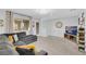 Bright living room featuring a large sectional sofa, entertainment center, and abundant natural light at 1180 Solano Hills Ct, Henderson, NV 89002