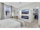 Relaxing bedroom offers a mounted TV, modern fireplace, and walk-in closet at 1180 Solano Hills Ct, Henderson, NV 89002