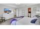 Well-lit bedroom boasts a dresser, mounted TV, and access to a bathroom at 1180 Solano Hills Ct, Henderson, NV 89002