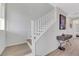 Well-lit staircase with white railings and modern flooring at 1180 Solano Hills Ct, Henderson, NV 89002
