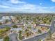 Spacious suburban property with a pool nestled among tree-lined streets under a blue sky with expansive city views at 14 Page St, Las Vegas, NV 89110