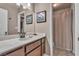 Bathroom with a modern vanity, framed mirror, and walk-in shower for a refreshed and functional space at 14 Page St, Las Vegas, NV 89110