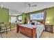 Bedroom with vibrant green walls, tiled floors, and natural light, showcasing a calm atmosphere and comfortable living space at 14 Page St, Las Vegas, NV 89110