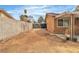 Wide shot of the side yard with a tall block wall offering a private space with potential for customization at 14 Page St, Las Vegas, NV 89110