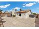 A backyard features gravel landscaping, a covered patio, and a stucco wall for privacy at 1403 Bareback Ct, Henderson, NV 89014