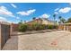 The backyard boasts gravel landscaping, a perimeter wall, and a covered patio at 1403 Bareback Ct, Henderson, NV 89014