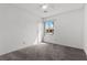 Inviting bedroom with large window, carpeted flooring, and a ceiling fan at 1403 Bareback Ct, Henderson, NV 89014