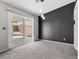 Serene bedroom featuring neutral walls, plush carpeting, and a sliding glass door at 1403 Bareback Ct, Henderson, NV 89014