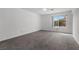 Bright bedroom with a window offering a view of the outside and plush carpet at 1403 Bareback Ct, Henderson, NV 89014
