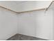 Simple closet space, ready for organization, with carpeting and wooden hanging rails at 1403 Bareback Ct, Henderson, NV 89014
