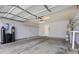 An empty two-car garage is brightly lit and features shelving and water filtration at 1403 Bareback Ct, Henderson, NV 89014