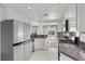 Modern kitchen with stainless steel appliances, granite countertops, and stylish checkered floors at 1403 Bareback Ct, Henderson, NV 89014