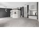 An open living area with pillars, gray walls, and carpet providing ample space for relaxation at 1403 Bareback Ct, Henderson, NV 89014
