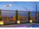 Well lit backyard with a fence and a beautiful view of the city at 154 Nine Mile Creek Dr, Las Vegas, NV 89138