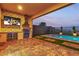 Inviting backyard with a covered patio, outdoor kitchen, and refreshing pool at 154 Nine Mile Creek Dr, Las Vegas, NV 89138