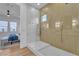 Luxurious bathroom with a sleek glass shower and a connecting view to the bedroom at 154 Nine Mile Creek Dr, Las Vegas, NV 89138