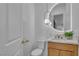 Bathroom featuring modern fixtures, a round mirror, and a wooden vanity at 154 Nine Mile Creek Dr, Las Vegas, NV 89138