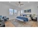 Bright bedroom with a ceiling fan, multiple windows, and comfortable seating area at 154 Nine Mile Creek Dr, Las Vegas, NV 89138