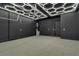 Spacious garage featuring unique geometric lighting and ample room for storage or a workshop at 154 Nine Mile Creek Dr, Las Vegas, NV 89138