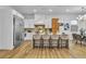 Bright kitchen with an island, stainless steel refrigerator, stylish pendant lighting, and hardwood floors at 154 Nine Mile Creek Dr, Las Vegas, NV 89138