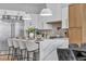 Elegant kitchen with a large waterfall island, breakfast bar, and stainless steel appliances at 154 Nine Mile Creek Dr, Las Vegas, NV 89138