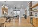 Open living space with adjacent dining area, featuring a modern light fixture, hardwood floors, and bar area at 154 Nine Mile Creek Dr, Las Vegas, NV 89138