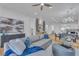 Bright and open living room with a sectional sofa, decorative pillows, and a view of the kitchen at 154 Nine Mile Creek Dr, Las Vegas, NV 89138