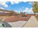 Community playground featuring a safe, cushioned ground, multiple swings, and various play structures for enjoyment at 154 Nine Mile Creek Dr, Las Vegas, NV 89138