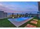 Dusk view of a modern pool with artificial turf, lounge chairs, and tasteful landscape lighting at 154 Nine Mile Creek Dr, Las Vegas, NV 89138