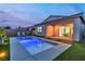 Backyard pool with artificial grass, covered patio, and sliding glass doors with interior view at 154 Nine Mile Creek Dr, Las Vegas, NV 89138