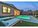 Backyard pool with lounge chairs, artificial grass and covered patio with cooking station and TV at 154 Nine Mile Creek Dr, Las Vegas, NV 89138