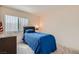 Well-lit bedroom with comfortable bed and large window at 1633 Broken Feather Dr, North Las Vegas, NV 89031