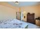 Comfortable bedroom features a ceiling fan, closet, and adjacent bathroom at 1633 Broken Feather Dr, North Las Vegas, NV 89031