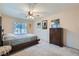 Bedroom featuring a ceiling fan, large window and a comfortable bed at 1633 Broken Feather Dr, North Las Vegas, NV 89031