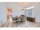Bright dining room featuring a large window and tile flooring with ample seating for six at 1633 Broken Feather Dr, North Las Vegas, NV 89031