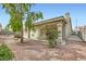 View of home exterior showcasing the covered patio and low-maintenance landscaping at 1633 Broken Feather Dr, North Las Vegas, NV 89031