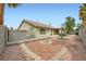 The backyard features desert landscaping, a fire pit, and a view of the home's exterior at 1633 Broken Feather Dr, North Las Vegas, NV 89031